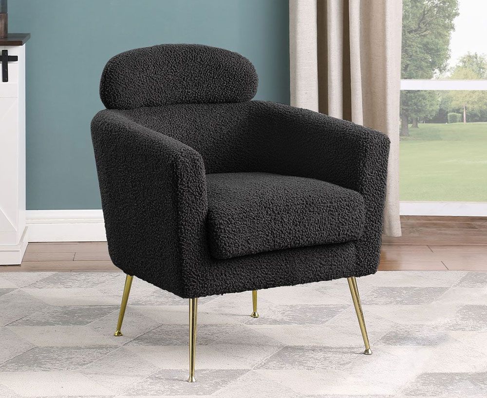 black boucle fabric upholstered accent chair with gold legs